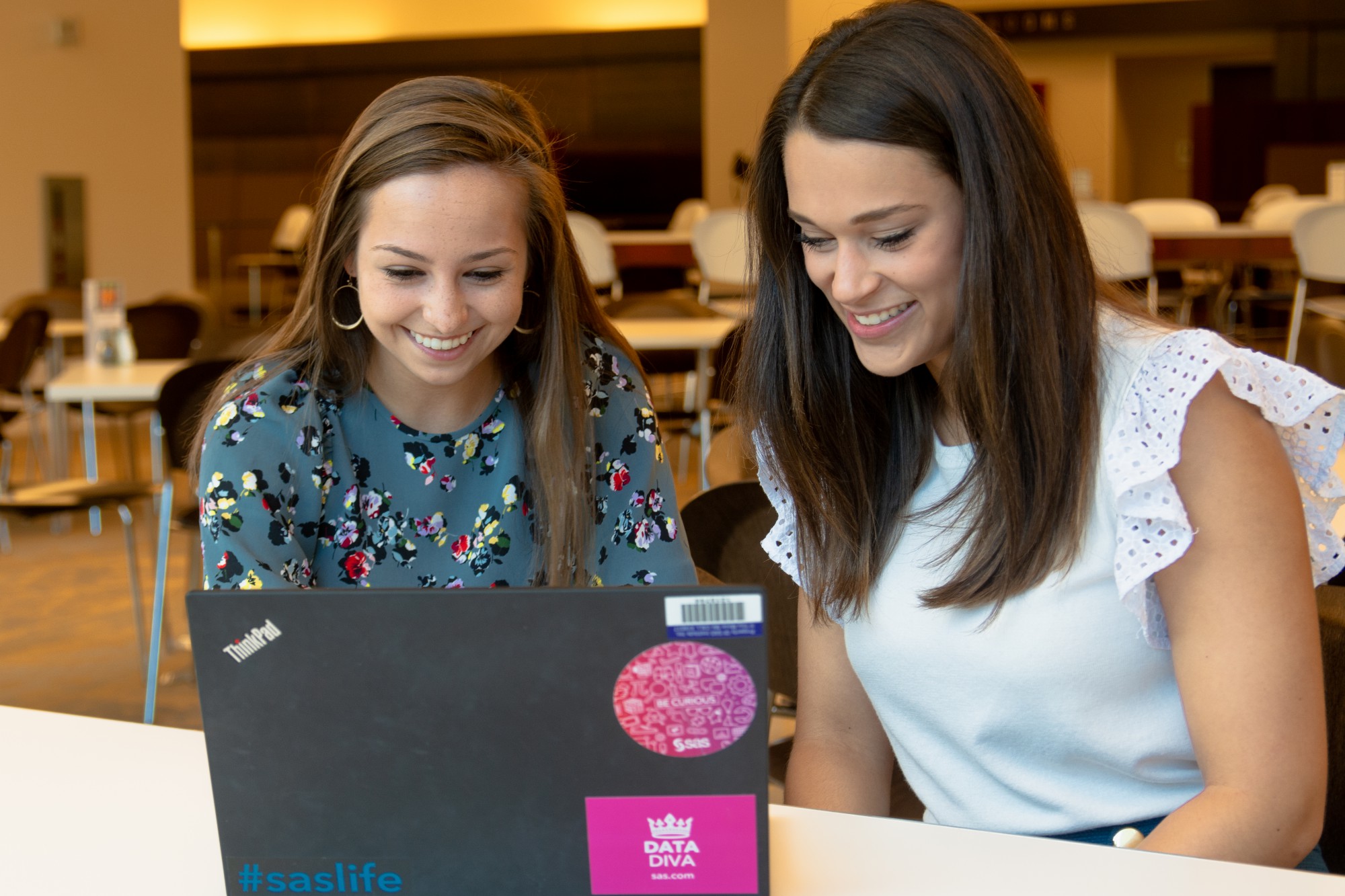 Two SAS interns working at a computer.